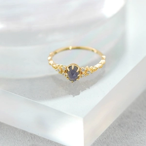 Vintage gold plated silver ring featuring oval iolite stone and sparkling side diamonds