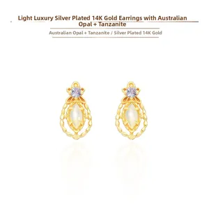 Detail of vintage 14K gold plated silver earrings with Australian opal and tanzanite