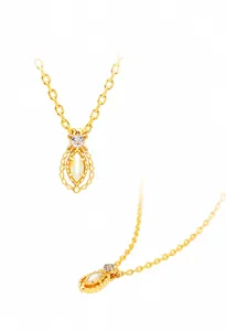 Detail of 14K gold plated necklace featuring a marquise cut opal stone and clear crystal
