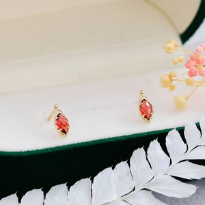 Detalle de pendientes vintage con piedras rojas de corte marquesa en caja de terciopelo