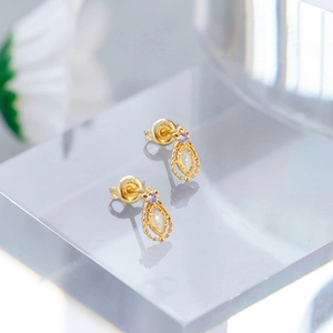 Elegant gold-plated opal stud earrings with filigree teardrop design and purple accent