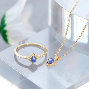 Detail of vintage gold-plated silver jewelry set with blue kyanite gemstones