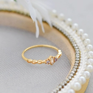 Macro shot of 14K gold plated opal ring with purple stones and wave texture band