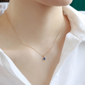 Detail of vintage rhombic kyanite pendant necklace in gold finish on female neck