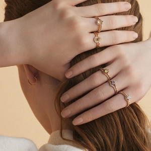 Set de anillos de plata S925 bañados en oro 14k con tanzanita y perlas en mano de modelo