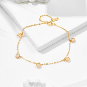Macro detail of S925 hallmark on gold plated chain with five opal gemstones