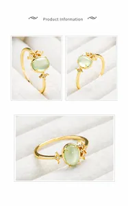 Detail of S925 sterling silver gold plated ring with oval green prehnite stone and zircon