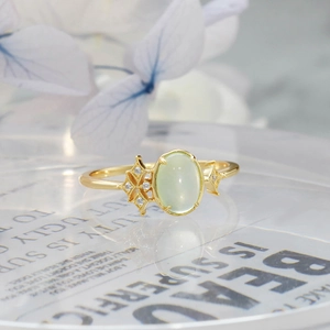 Macro shot of oval prehnite gemstone ring in 14K gold plating with star details