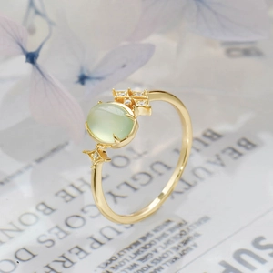 Detail shot of a S925 silver 14K gold plated ring with green prehnite and side stones