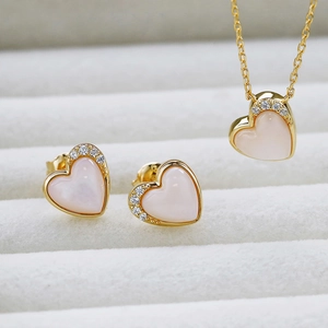 Detail of S925 silver 14K gold plated heart pendant and earrings with pink shell