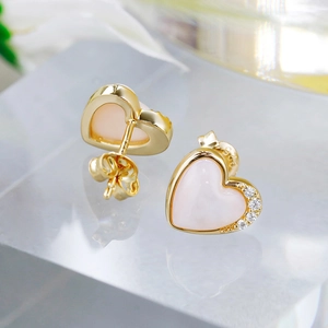 Macro shot of 14K gold plated S925 silver heart stud earrings with pink shell and zircons