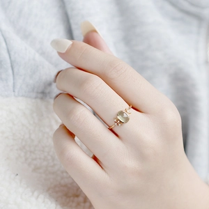 Detail view of gold S925 silver ring with oval prehnite stone and star accents