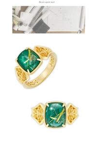 Macro detail of vintage S925 silver ring with green malachite and intricate gold filigree