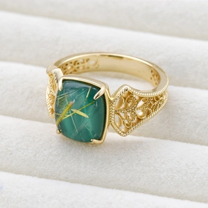 Detailed macro view of vintage S925 silver ring featuring green crystal and filigree