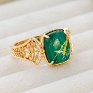 Detailed close-up of retro S925 silver ring with green malachite and rutilated quartz