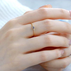 Macro detail of minimalist S925 silver ring with tanzanite stone and small diamonds
