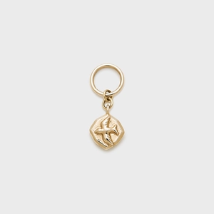 Macro shot of 14K gold-plated octagonal pendant featuring a bird relief and large bail ring