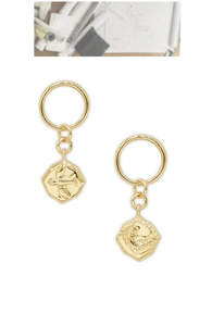 Detailed macro view of 14K gold plated hexagon drop earrings with vintage embossed patterns