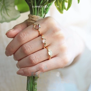 Close-up of vintage S925 silver 14K gold plated rings with natural prehnite and white stones