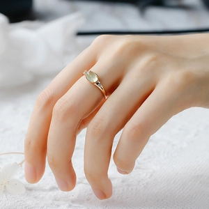 Detail view of a French vintage S925 silver ring with green prehnite on a model finger
