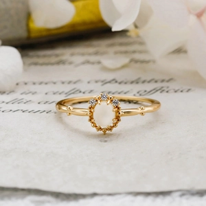 Macro detail of retro S925 silver gold-plated ring with moonstone and white zircons