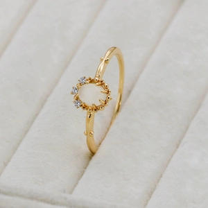 Macro detail of vintage gold branch ring with white moonstone and zircon accents