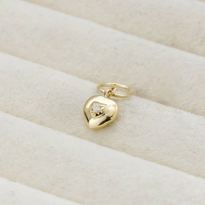 Detail shot of heart pendant in 14K gold plating with star-set sparkling zircon stone