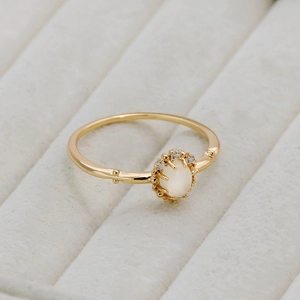 Macro detail of 14K gold S925 silver ring featuring moonstone and white zircons
