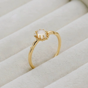 Macro shot of gold moonstone ring with zircon accents and delicate bead details