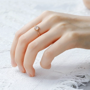 Macro detail of a vintage 14K gold plated silver ring with moonstone and white zircons