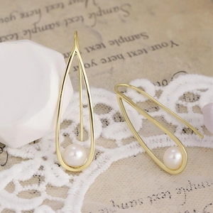 Detailed macro view of S925 silver 14K gold-plated teardrop earrings with freshwater pearls