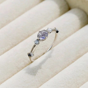 Macro detail of S925 silver ring with lavender round stone and blue square accents