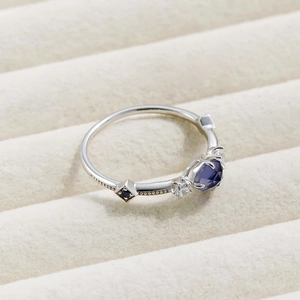 Detailed view of S925 silver ring featuring blue sapphire and beaded metal edges