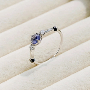 Macro detail of S925 silver ring with oval purple gemstone and symmetrical side stones