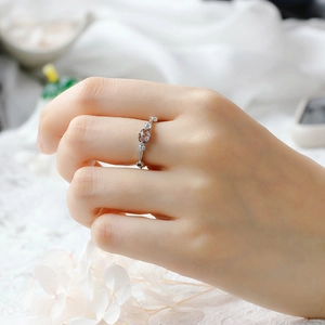 Detail of vintage silver ring with oval smoky gemstone and side zircon accents