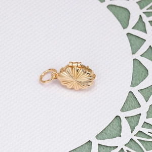 Macro view of a French vintage 14k gold-plated S925 silver openable locket pendant.