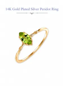 Detail of S925 silver 14K gold plated ring with marquise-cut green peridot stone