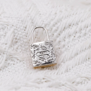 Detail view of S925 silver locket pendant with leaf relief and 2023 engraving