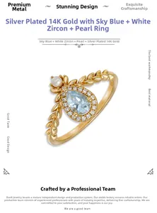 Detail of 14k gold plated S925 silver ring with blue topaz, pearl and leaf relief