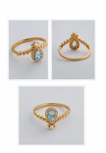 Detailed view of teardrop blue topaz S925 silver ring with pearl and gold plating