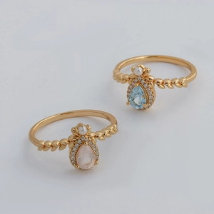 Detail of 925 sterling silver rings with teardrop gemstones and wheat texture design
