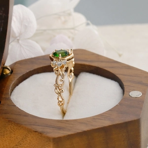 Macro detail of vintage S925 silver ring with oval green gemstone and hollow vine patterns
