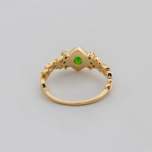 Detailed macro view of S925 silver 14K gold ring with green chrome diopside and diamonds