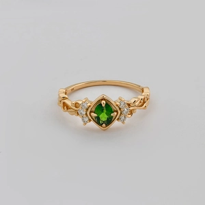 Detail view of S925 sterling silver stamp on vintage gold ring with green gemstone