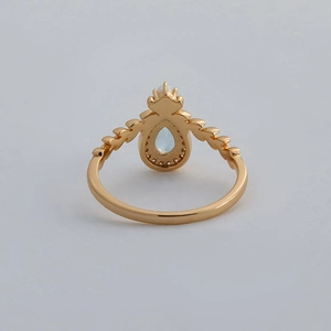 Macro view showing the hollow-out setting and leaf pattern on a 14k gold-plated ring