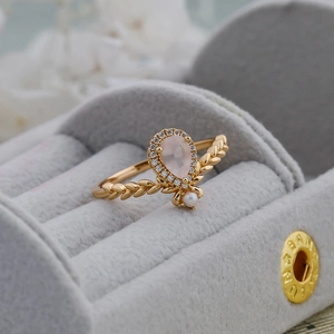Macro detail of crown ring with pear pink crystal, leaf texture and white pearl