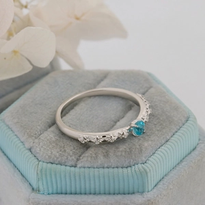 Detailed macro shot of S925 silver thorn rose ring featuring a blue apatite stone