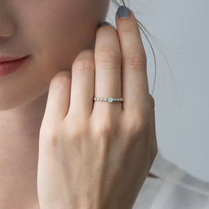 Detail of vintage thorn rose ring in S925 silver with a light blue apatite gemstone