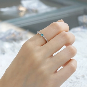Macro shot of S925 silver ring featuring blue apatite stone and vintage thorn design