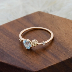 Macro shot of Sky Blue Topaz and yellow gemstone set in 14K gold plated silver band